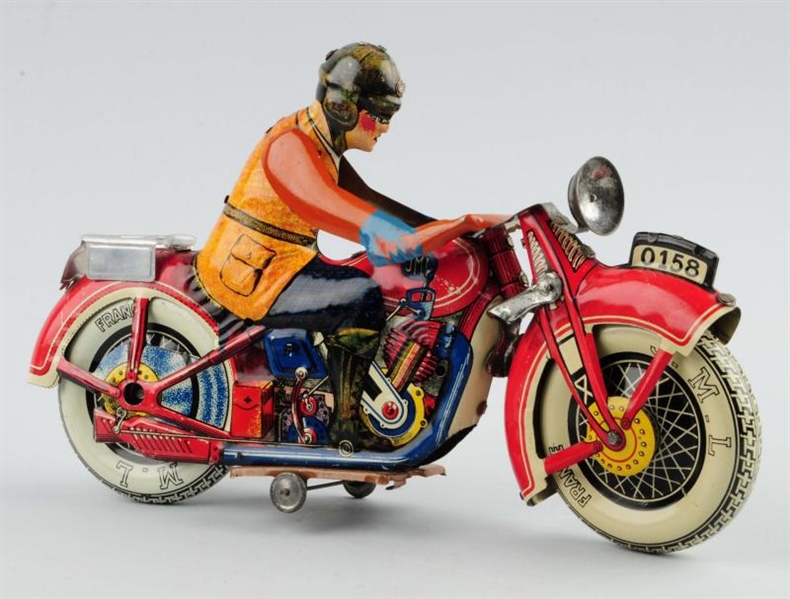 J.M.L. TIN LITHO WIND-UP MOTORCYCLE TOY.          