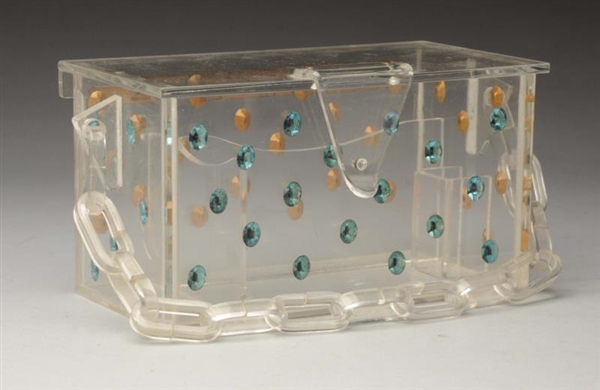 LUCITE PURSE WITH JEWELS.                         