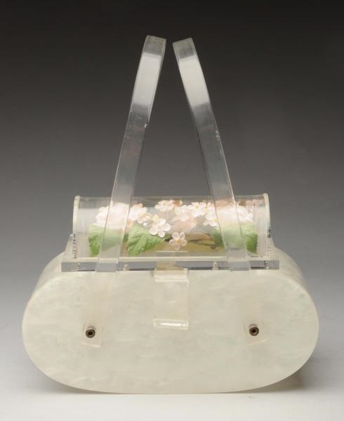 LUCITE PURSE WITH ENCASED FLOWERS.                