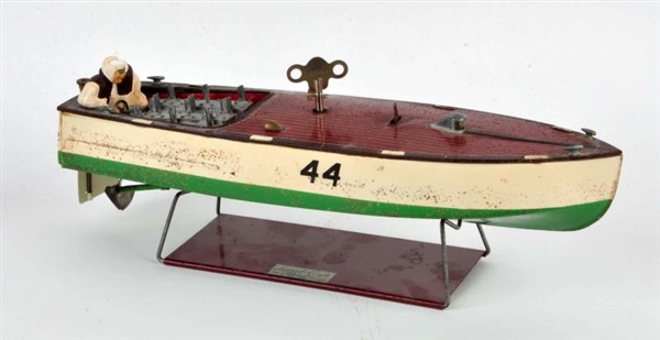 TIN SPEED BOAT WITH KEY AND MEN IN BOAT           