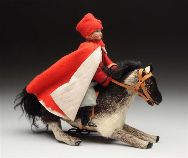 UNUSUAL DOLL RIDING GALLOPING HORSE.              