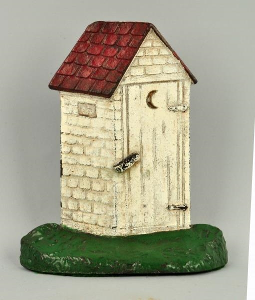 CAST IRON OUTHOUSE DOORSTOP.                      