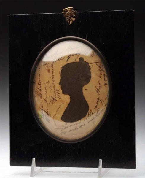 FRAMED SILHOUETTE OF LADY UNDER GLASS.            