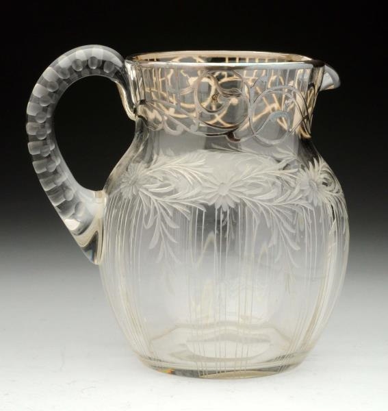 A SILVER OVERLAY PITCHER.                         