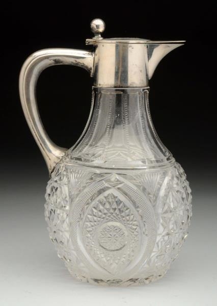 A CONTINENTAL SILVER MOUNTED GLASS JUG.           