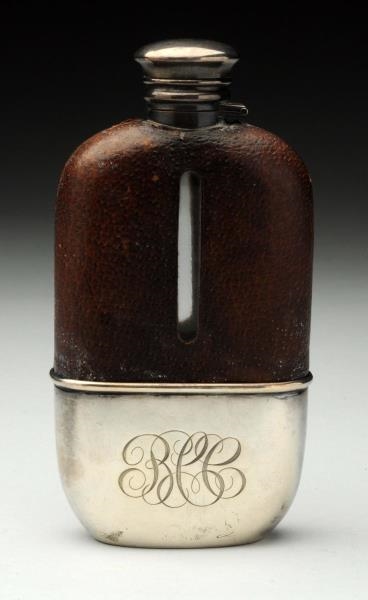 STERLING AND LEATHER COVERED FLASK.               