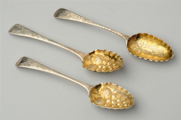 THREE ENGLISH SILVER BERRY SPOONS.                