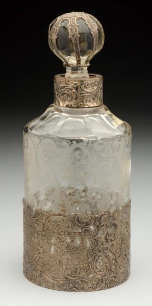 A SILVER MOUNTED PERFUME BOTTLE.                  