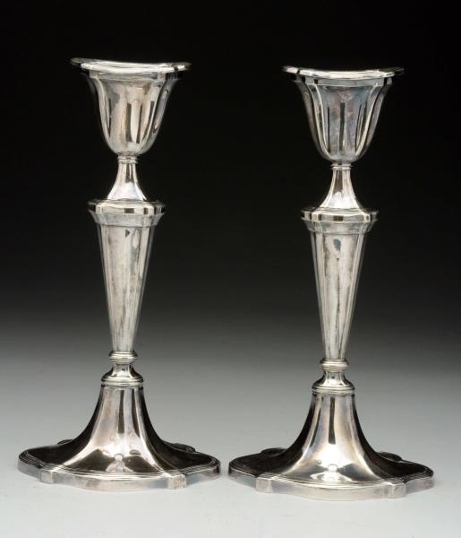 A PAIR OF SILVER PLATED CANDLESTICKS.             