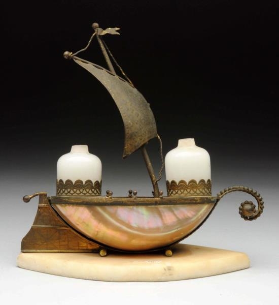BRONZE INKWELL SET IN SHAPE OF A SHIP.            