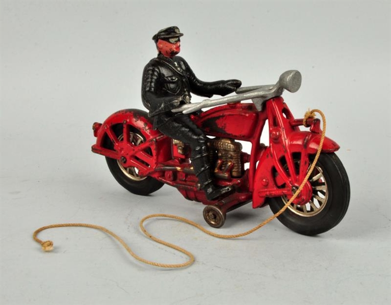 CAST IRON MOTORCYCLE WITH DRIVER.                 