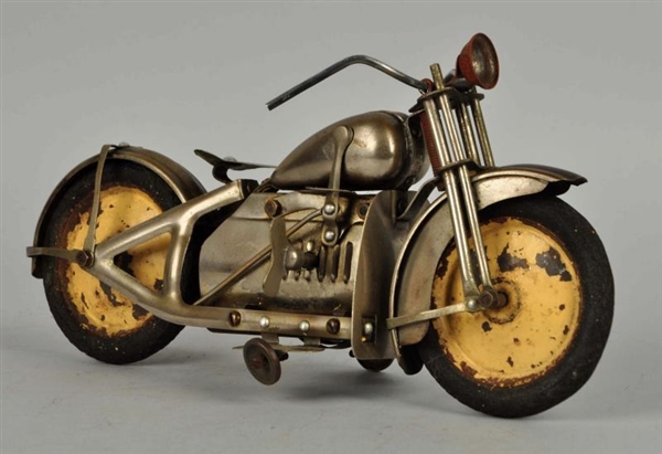 FOREIGN MADE TIN WIND-UP MOTORCYCLE TOY.          