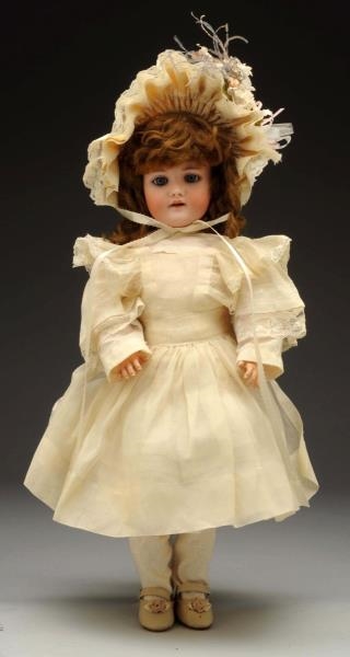 BISQUE DOLL WITH WHITE DRESS.                     
