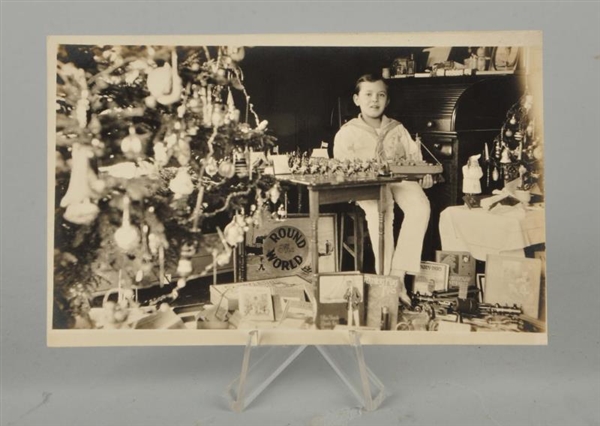REAL PHOTO POST CARD OF BOY AND CHRISTMAS GIFTS.  