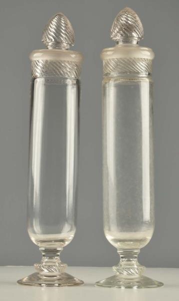 LOT OF 2: TALL APOTHECARY GLASS JARS.             