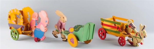 LOT OF 3: LARGE WOODEN EASTER RABBITS WITH WAGONS.