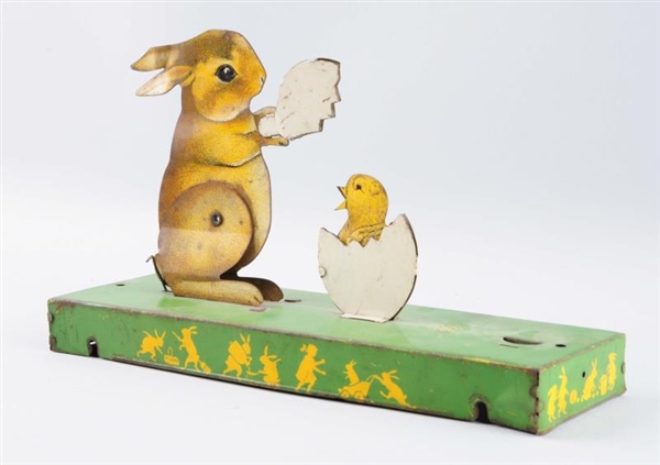TIN LITHO RABBIT WITH LITTLE CHICK IN EGG.        