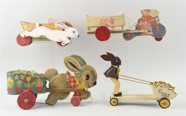 LOT OF 4: WOODEN RABBITS WITH WAGONS.             