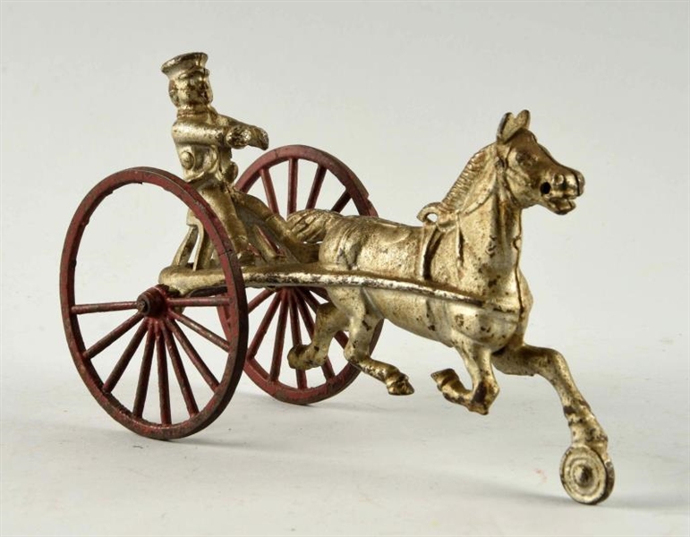 CAST IRON RED WHEEL CART WITH HORSE.              