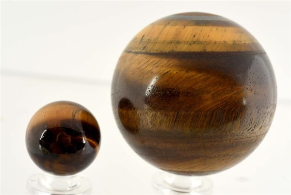 LOT OF 2: EARLY TIGER EYE MARBLES.                