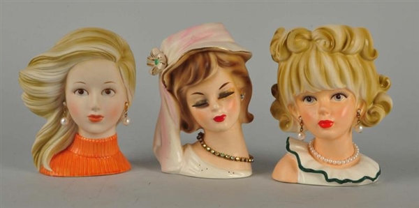 LOT OF 3: SMALL LADY HEAD VASES.                  