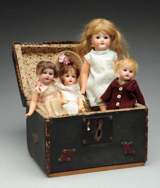 LOT OF 4: BISQUE DOLLS IN TRUNK.                  