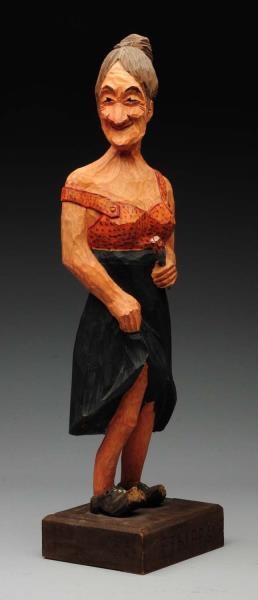CARVED WOODEN STATUE OF WOMAN HOLDING FLOWER.     