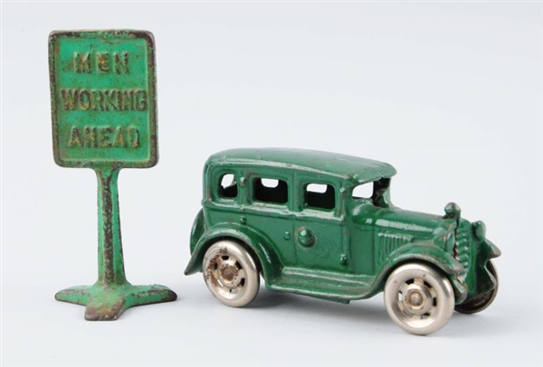 LOT OF 2: GREEN CAST IRON CAR & SIGN.             
