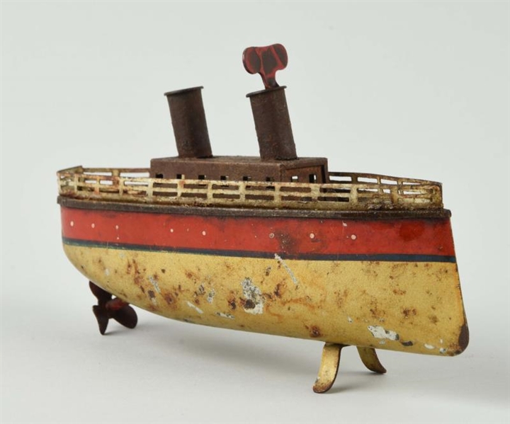 TIN WIND-UP BOAT WITH RED STRIPE.                 