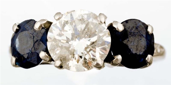 A DIAMOND AND SAPPHIRE RING.                      