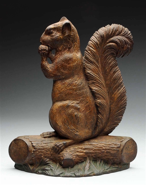 CAST IRON SQUIRREL WITH NUT DOORSTOP.             