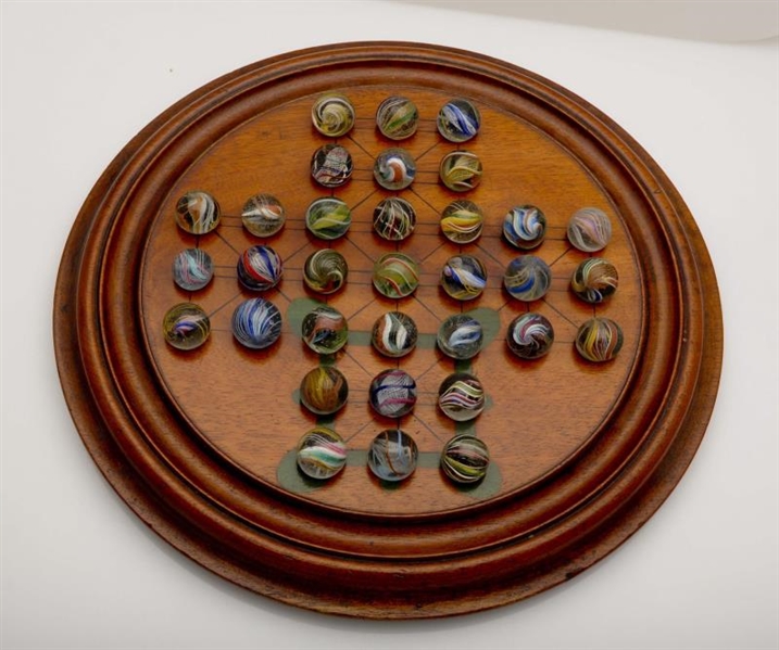 SOLITAIRE GAME BOARD WITH SWIRL MARBLES.          