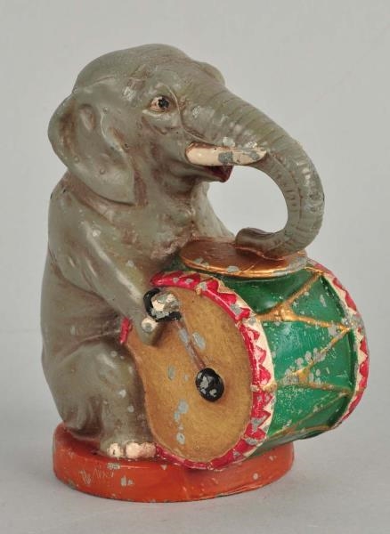 DIECAST SEATED ELEPHANT PLAYING DRUM STILL BANK.  