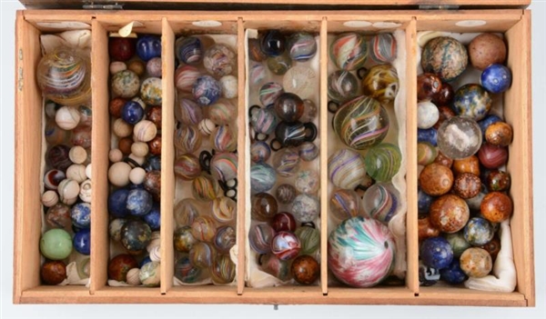 OVER 140 MARBLES IN WOODEN CASE.                  