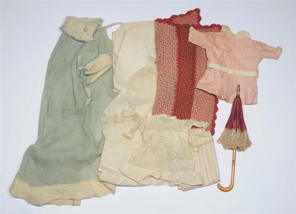 LOT OF DOLLS CLOTHING AND PARASOL.                