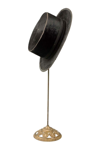 CAST IRON HAT DISPLAY WITH HAT.