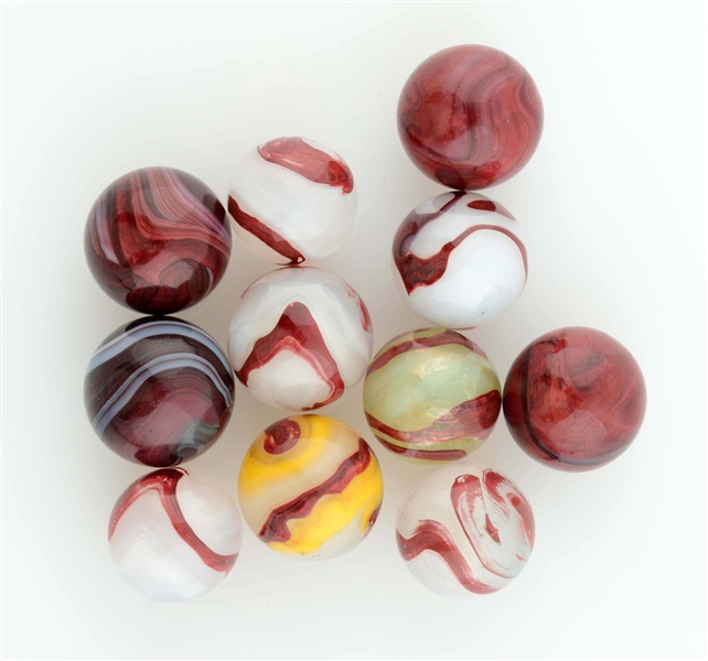 LOT OF 11: OXBLOOD MARBLES.                       
