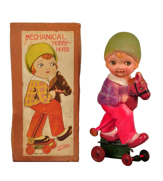 JAPANESE GIRL RIDING HOBBY HORSE CELLULOID TOY.   