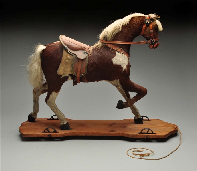 VINTAGE STRAW FILLED HORSE PULL TOY.              
