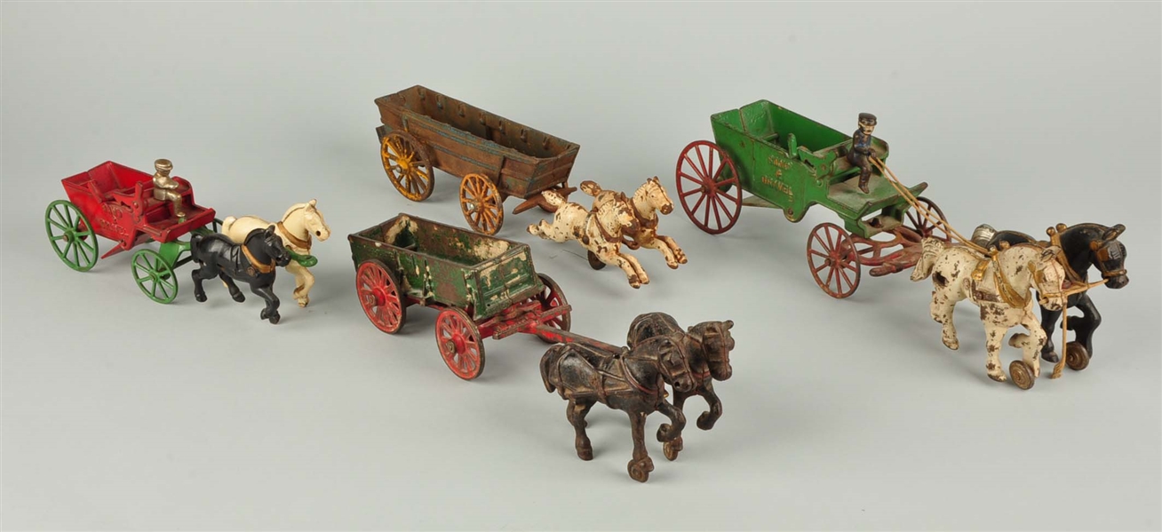 LOT OF 4: CAST IRON HORSE DRAWN WAGONS.