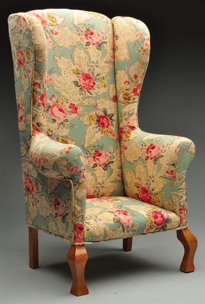 UPHOLSTERED DOLL-SIZED CHAIR WITH FLORAL DESIGN.