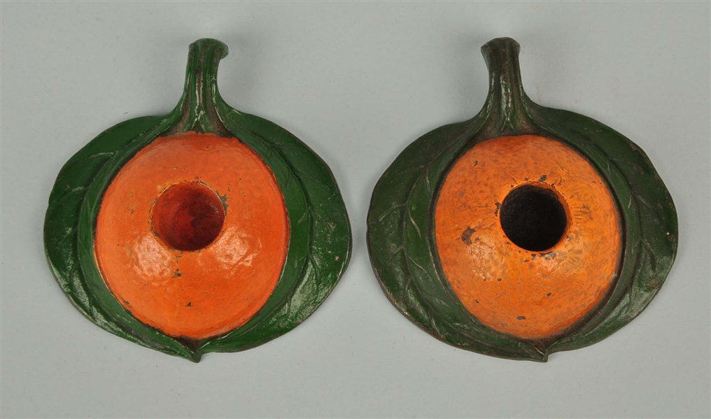 LOT OF 2: CAST IRON ORANGE GO TO BED CANDLE HOLDERS.