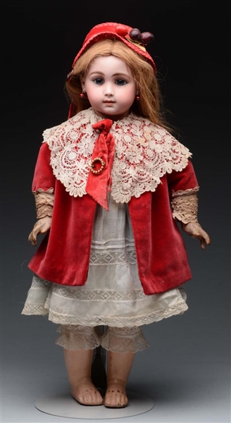 BISQUE HEAD DOLL IN RED VELVET CAPE AND HAT.      