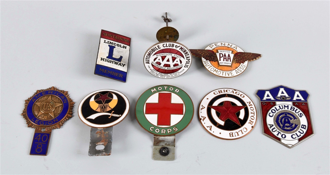 LOT OF 8: ENAMEL RADIATOR BADGES & LICENSE PLATE ATTACHMENTS.