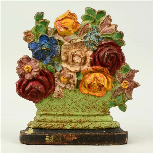 CAST IRON OLD FASHION MIXED FLOWERS IN URN WEDGE DOORSTOP.