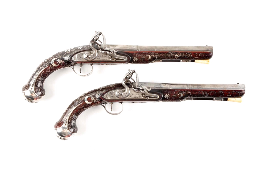 (A) FINE PAIR OF PROFUSELY DECORATED ENGLISH SILVER MOUNTED PISTOLS FOR THE EASTERN MARKET BY WALKLATE.