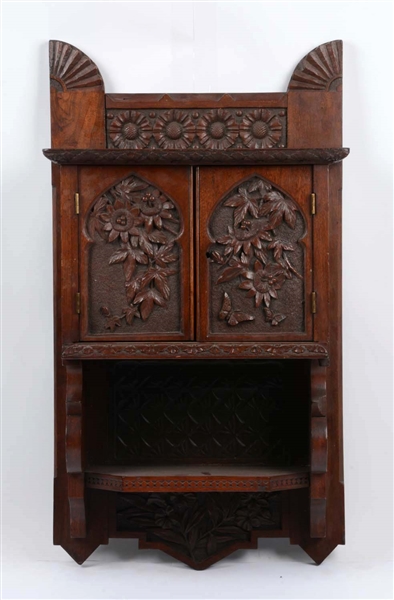 CARVED WALNUT WALL CABINET. 