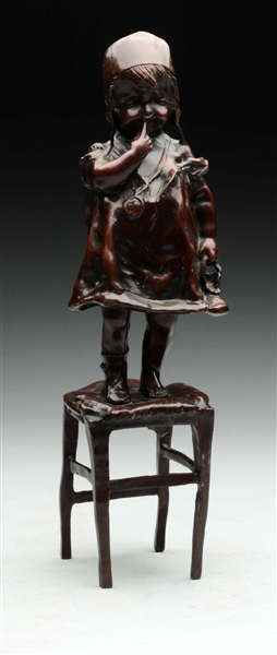 FIGURAL BRONZE GIRL STANDING ON CHAIR. 