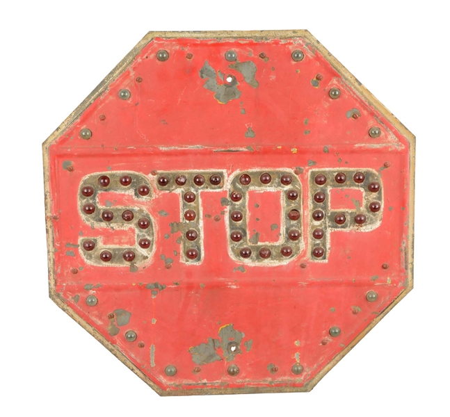 RED STOP SIGN WITH RED AND CLEAR JEWELS.