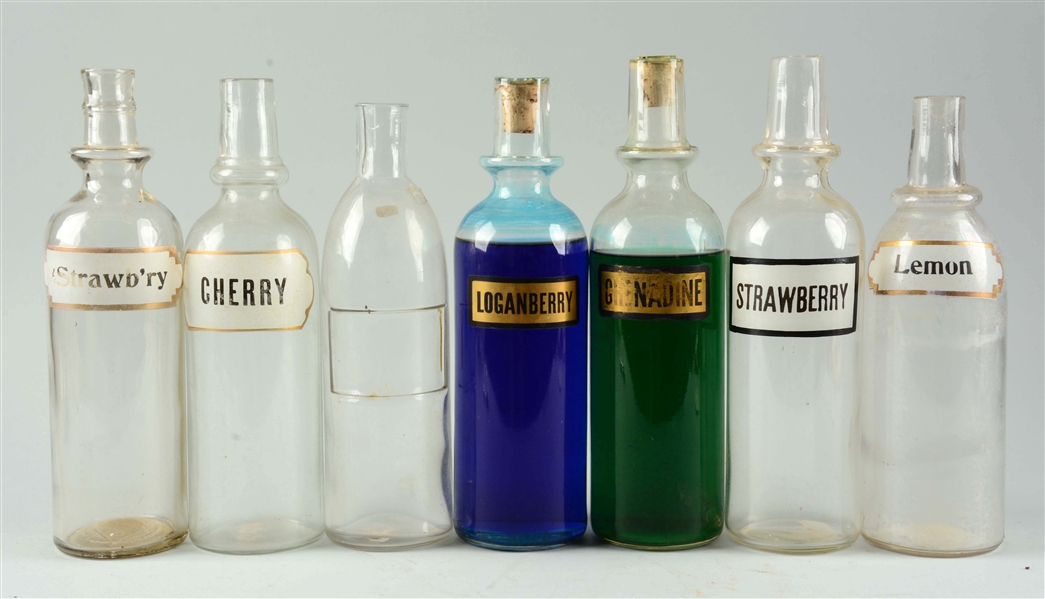 LOT OF 7: ASSORTED GLASS SYRUP BOTTLES. 